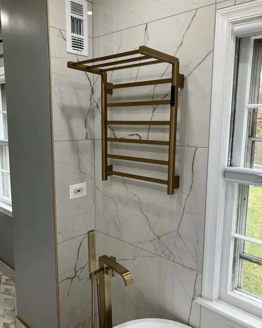 Gold towel warmer beside a window