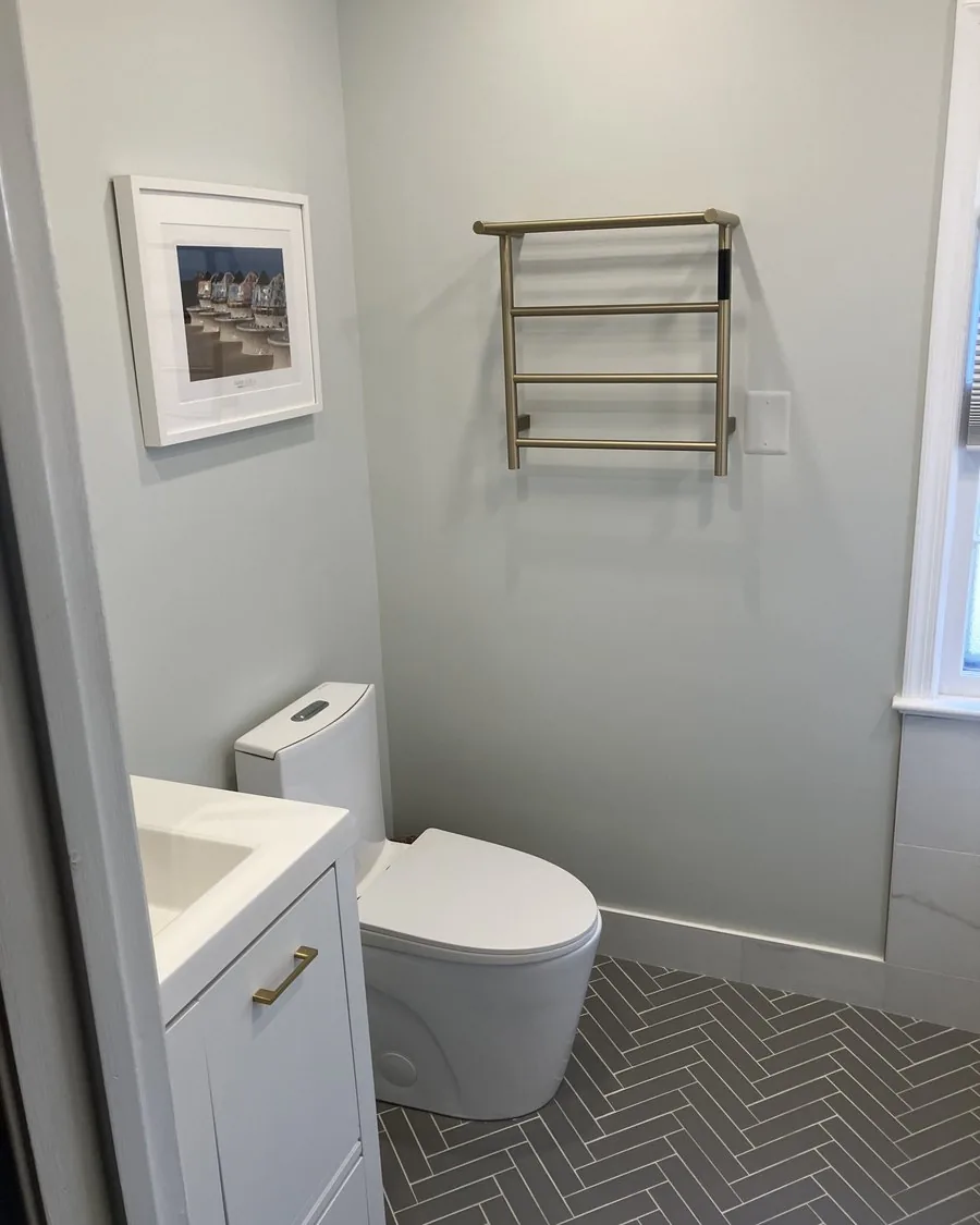 Small bathroom with a herringbone tile floor