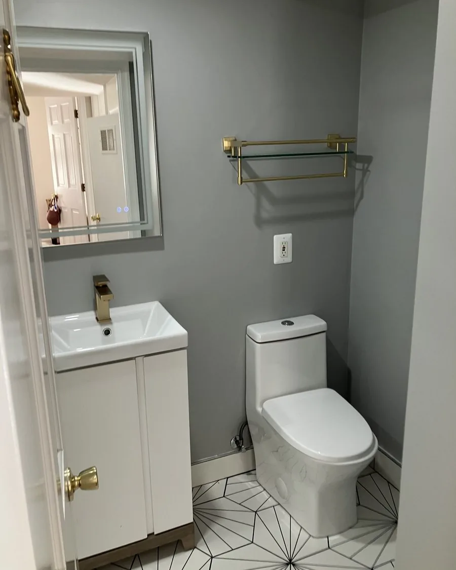 Vanity and toilet over starburst floor tile